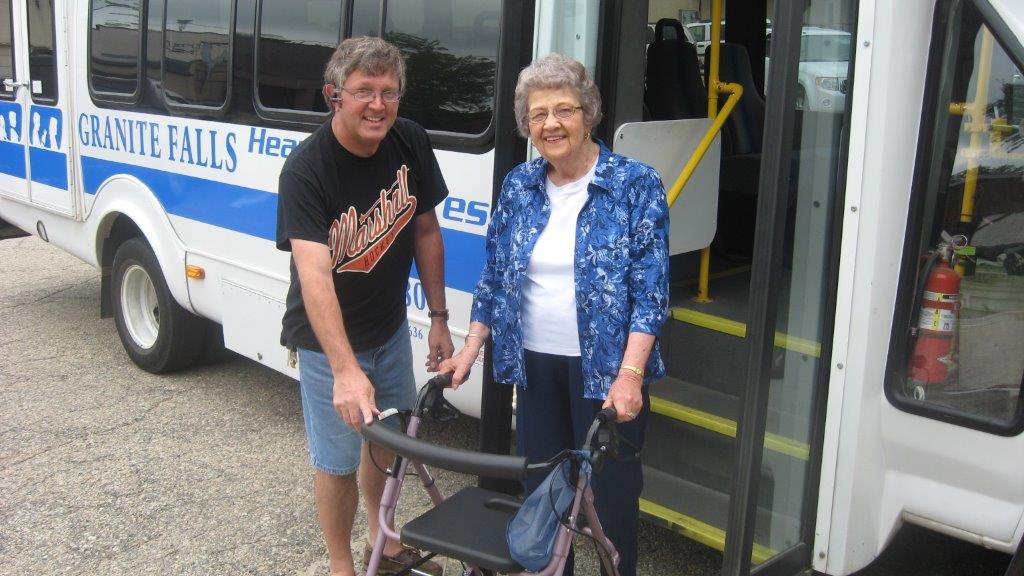 Greater Minnesota provider helping an elderly passenger off the bus
