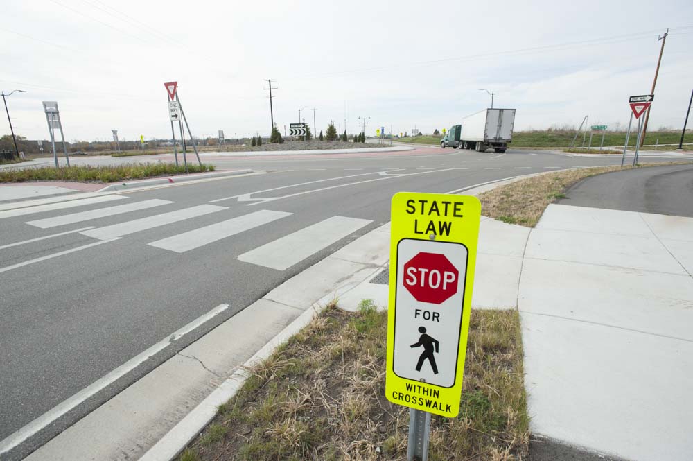 Bicyclists ride on bike trail next to lake in Twin Cities 